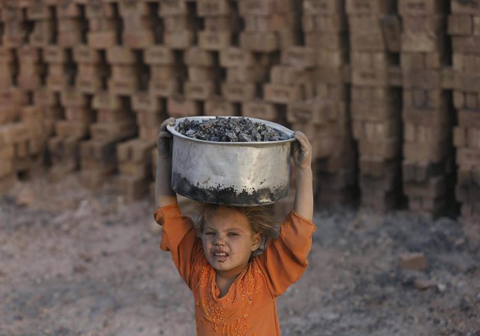 Laila, 8, works at a brick-making factory outside Kabul, Afghanistan